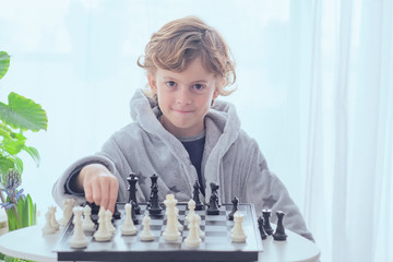 Boy holding figure on chess board