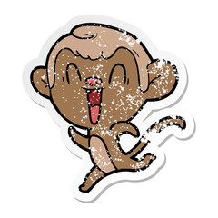 distressed sticker of a cartoon laughing monkey