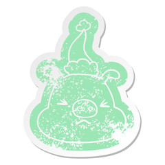 cartoon distressed sticker of a angry pig face wearing santa hat