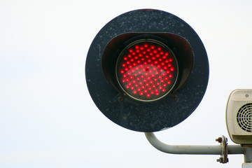 red traffic lights at a railway crossing