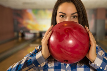 Fototapeta na wymiar Gorgeous young female bowling player posing with the bowling ball