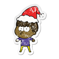 distressed sticker cartoon of a curious boy wearing santa hat