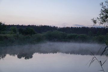 Pretty river in the countryside is shrouded in mist. European landscape of Russia and Siberia. calm view of nature. Stock background, photo
