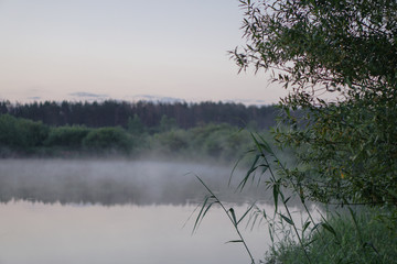 Pretty river in the countryside is shrouded in mist. European landscape of Russia and Siberia. calm view of nature. Stock background, photo