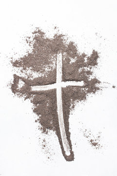 Cross and ash on white background - symbol of Ash Wednesday. Copy space © czarny_bez