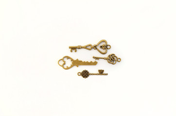 Decorative keys of different sizes, stylized antique on a white background. Form the centerpiece. four keys