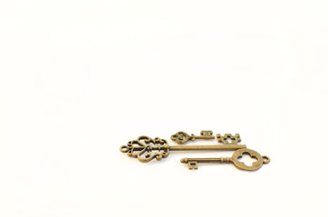 Decorative keys of different sizes, stylized antique on a white background. Form the centerpiece. three keys