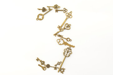 Decorative keys of different sizes, stylized antique on a white background. Form the centerpiece. Number three
