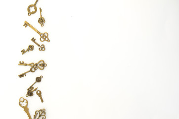 Decorative keys of different sizes, stylized antique on a white background. On the left border of the frame