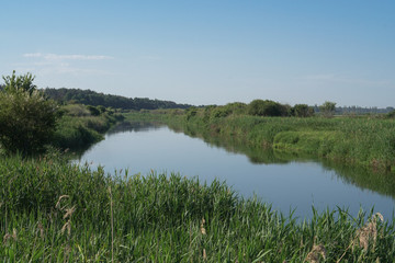 Pretty river in rural areas. European landscape of Russia and Siberia. Beautiful tranquil view of nature. Stock background, photo.