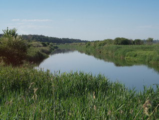 Pretty river in rural areas. European landscape of Russia and Siberia. Beautiful tranquil view of nature. Stock background, photo.