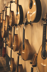 different portuguese guitars on wall