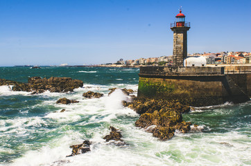 Old stone lighthouse and ocean view in Porto, Portugal