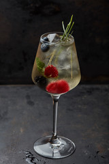 cocktail with berries and lemongrass