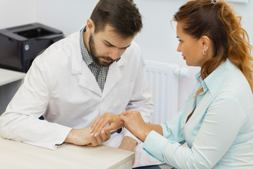 Professional dermatologist examining birthmarks and moles of a patient