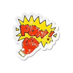 retro distressed sticker of a cartoon boxing glove punching