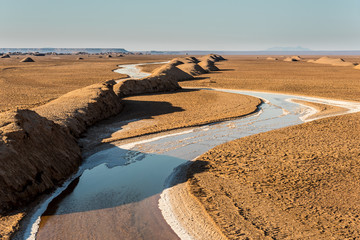 View of salt Rud-e Shur river inside egg  mountains, yardangs in Kaluts desert, part of Dasht-e Lut desert in province Kerman, Iran