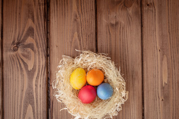 Colorful Easter eggs on wooden background with copy space