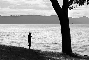 silhouette of a young boy fishing