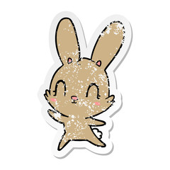 distressed sticker of a cute cartoon rabbit dancing