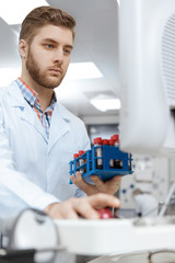 Young male scientist working with blood samples using a computer at the laboratory