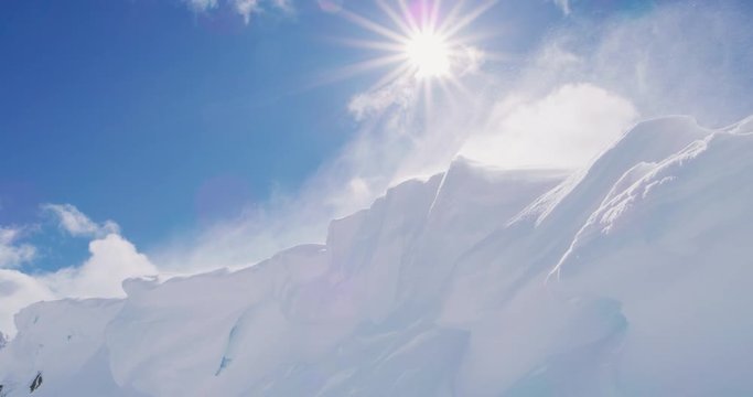 Backcountry cornice with wind and snow on a sunny day, winter nature ski scene