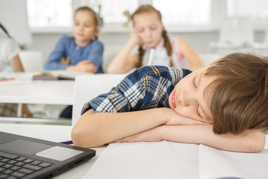 Young Girl Looking Bored Studying At School