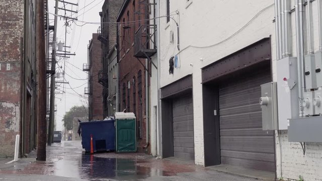 Rain in an alley with a dumpster