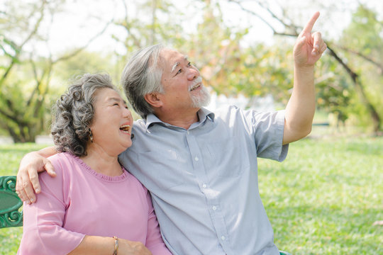 Happy elderly couple with lifestyle after retiree concept. Lovely asian seniors couple embracing together in the park in the morning.