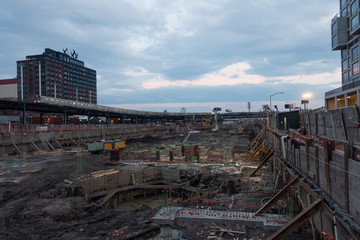 construction site with foundation and train at night