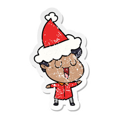 laughing distressed sticker cartoon of a man wearing santa hat