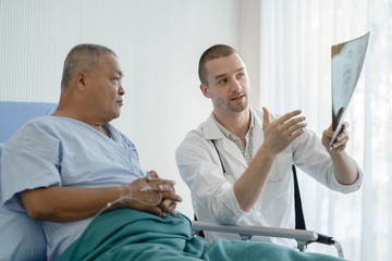 Doctor showing result of radiography to patient and giving diagnosis.