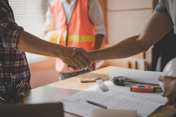 Successful deal, male architect shaking hands with client in construction site after confirm...