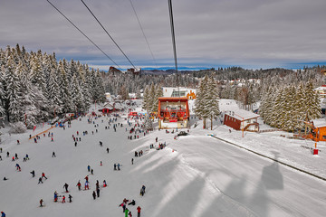 Poiana Brasov, Romania -16 January 2019: Skiers and snowboarders enjoy the ski slopes in Poiana...