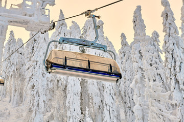 Chair lift in Poiana Brasov ski resort, Skiers and snowboarders enjoy the ski slopes in Poiana...