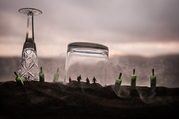 Iron handcuffs for the arrest of criminals, a glass of vodka on a wooden. background. a crime...