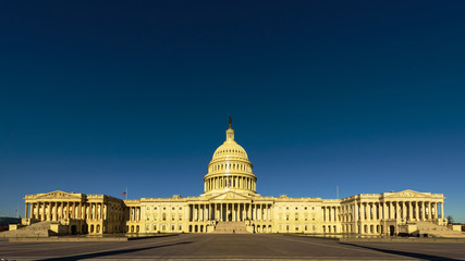 Wide angle view of The United States Capitol building in the morning with blue sky, Washington DC © Yaya Ernst