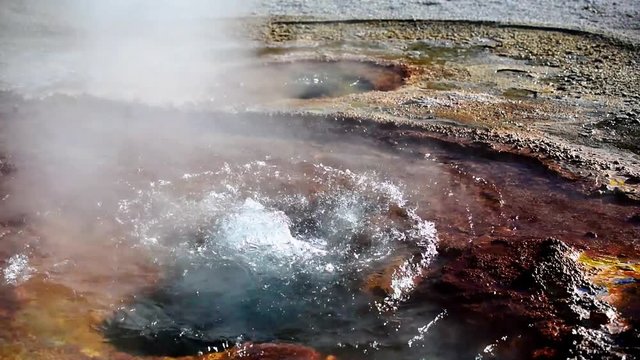 Bubbling water in geyser pool in Yellowstone National Park, Wyoming, USA.
