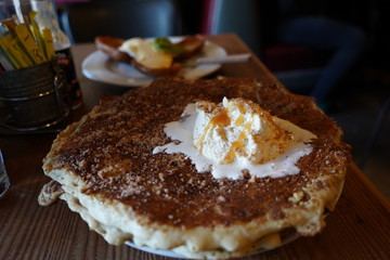 Ice cream melting on pancake with syrup