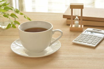 A cup of coffee on a wood table
