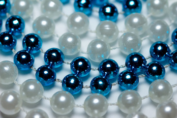 Circle abstract background of vibrant blue and white necklace beads