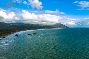 Drone image of Oregon Coast and Humbug Mountain in Port Orford, dramatic cloudscape