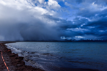 Cumulonimbus storm raining in the Namtso ( or Lake Nam; Nam Co), which is a mountain lake in...