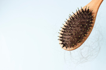 comb with loose hair on a blue background