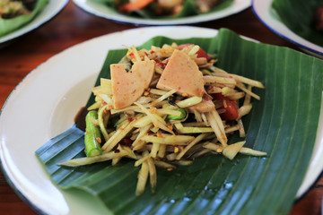 Spicy papaya salad with vietnamese pork sausage Thai traditional food “Som Tum Moo Yor”