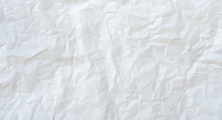 Crumpled white paper background.