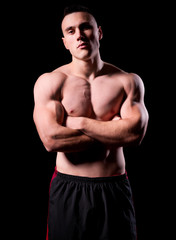 Fototapeta premium Young strong man isolated