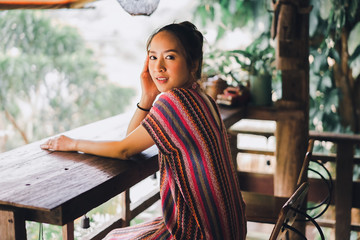 portrait of asian women in lanna uniform from thailand north by sit relax looking to mountain and nature with concept relaxing in travel and vacation