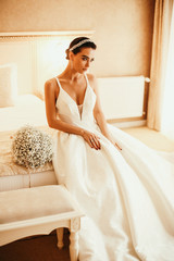 Obraz na płótnie Canvas beautiful sensual bride with dark hair in luxurious wedding dress and accessories