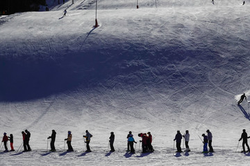 Orsa, Dalarna province, Sweden Downhill skiers waiting in line at a ski lift in the Orsa ski resort on a sunny day.
